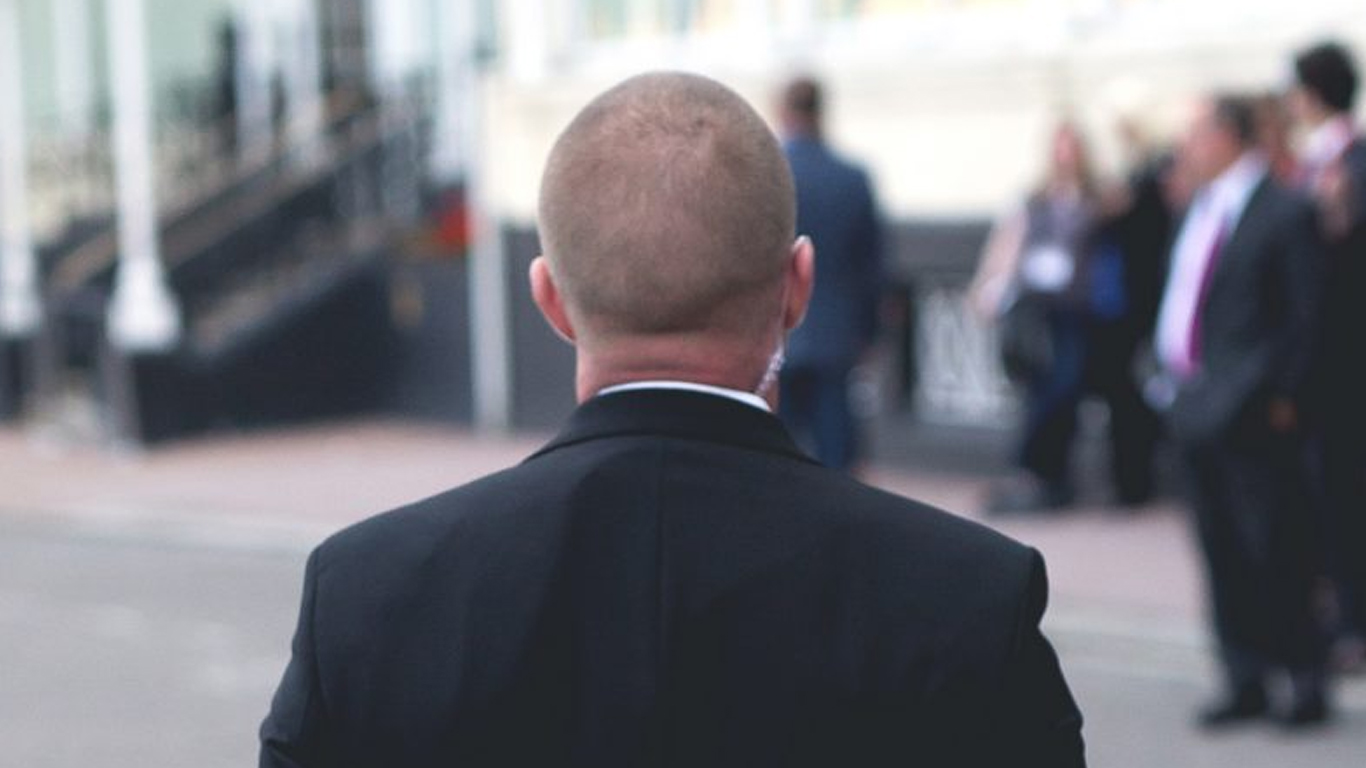 Close protection officer assessing the area surrounding the Grand Hotel, Brighton