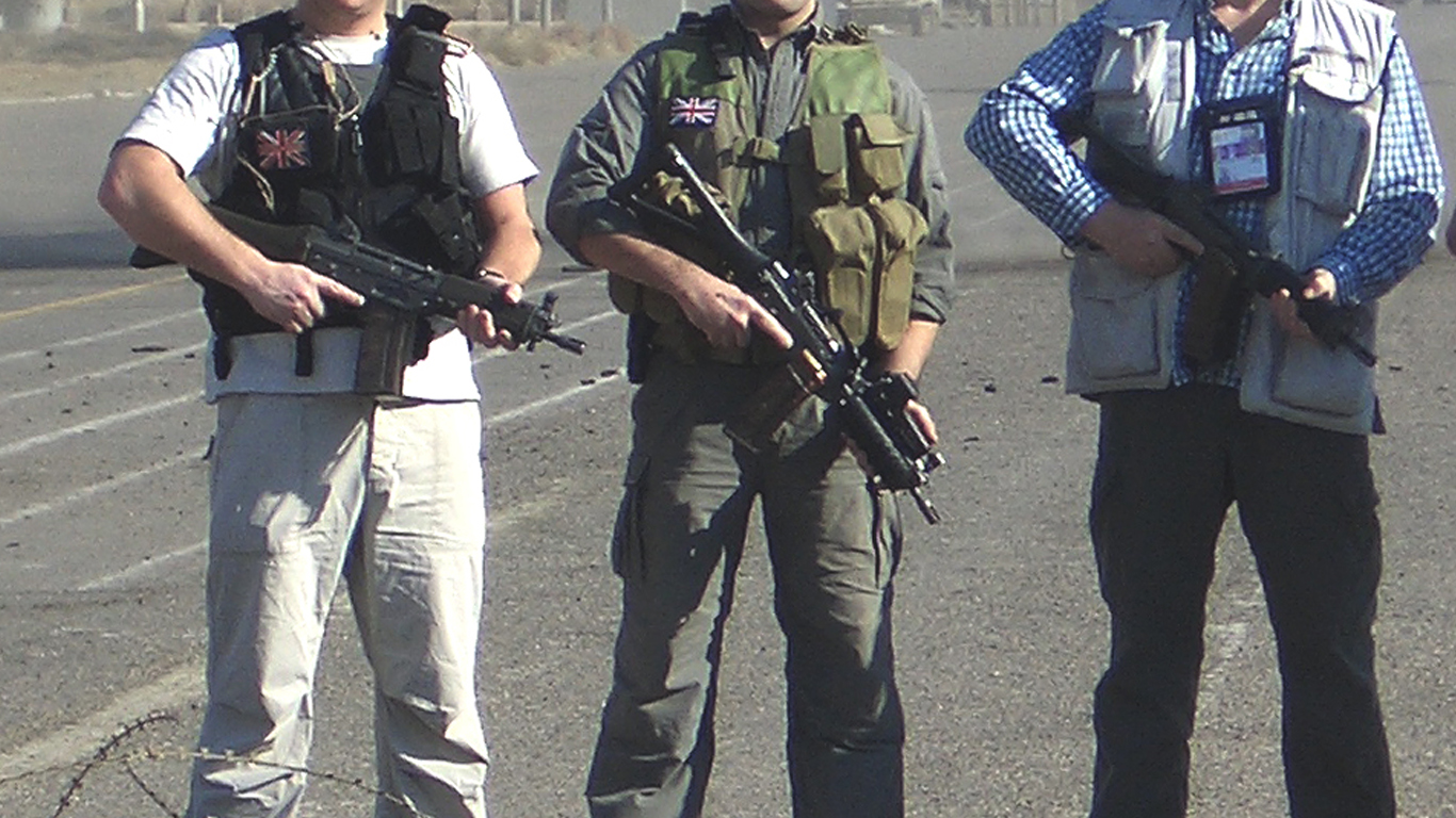 Three Consec Hostile Environment operatives wearing bullet proof vests holding assault weapons